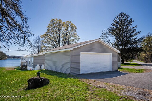detached garage featuring a water view