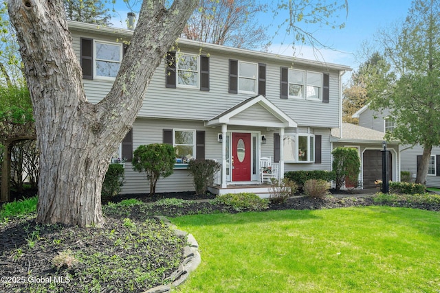 colonial inspired home featuring a front lawn