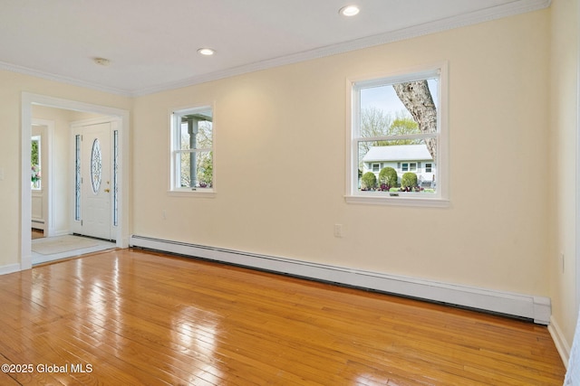entryway with recessed lighting, ornamental molding, baseboard heating, and wood-type flooring