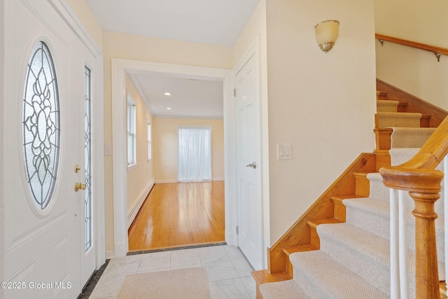entrance foyer with recessed lighting, baseboards, and stairs