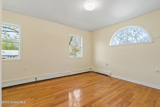 unfurnished room featuring baseboards, plenty of natural light, and light wood finished floors