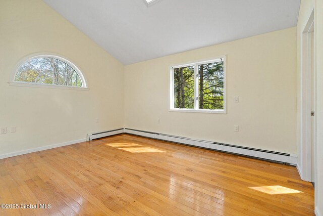 unfurnished room with wood-type flooring, a baseboard heating unit, and lofted ceiling