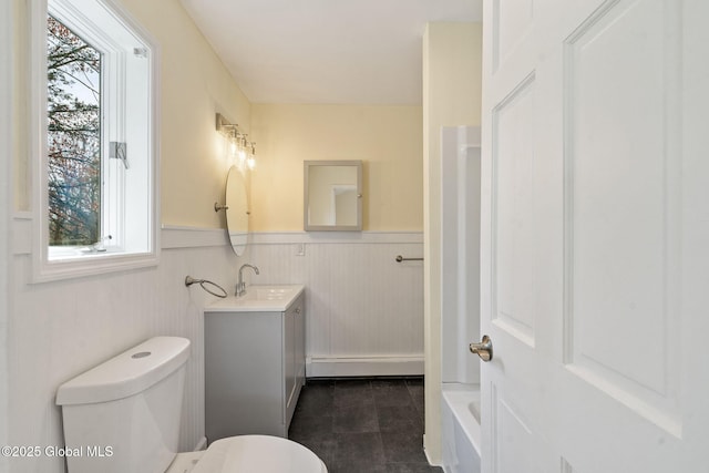 bathroom featuring vanity, toilet, wainscoting, and a baseboard radiator