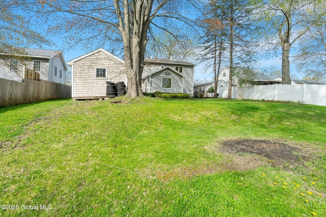 view of yard featuring a fenced backyard and an outdoor structure