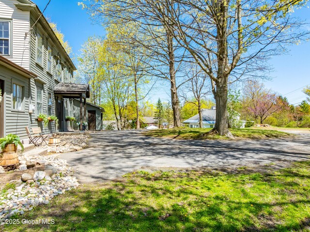 view of yard with driveway and a garage