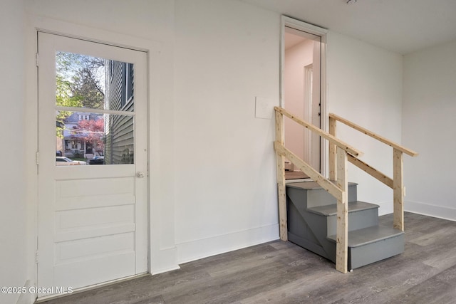interior space featuring baseboards and wood finished floors