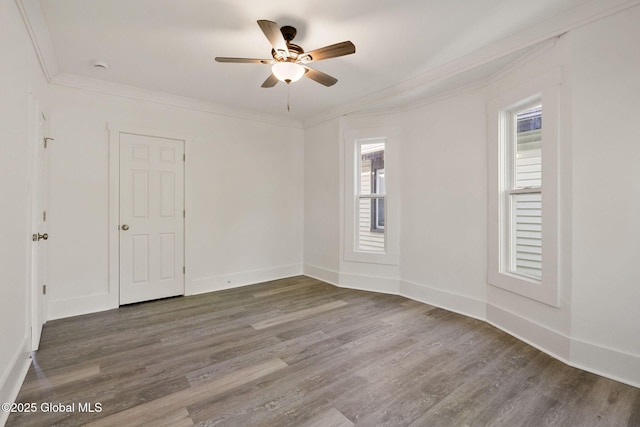 empty room with a ceiling fan, baseboards, ornamental molding, and wood finished floors