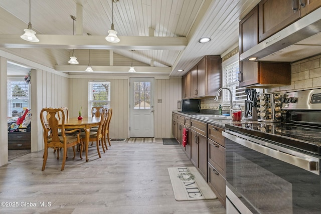 kitchen featuring stainless steel electric range oven, dark countertops, a sink, light wood-style flooring, and under cabinet range hood