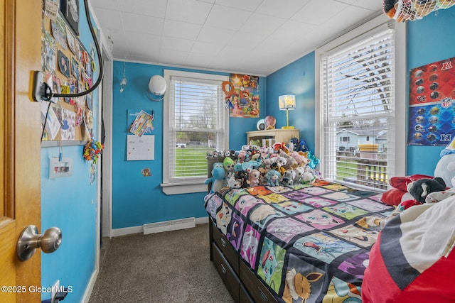 carpeted bedroom with baseboards and a baseboard radiator