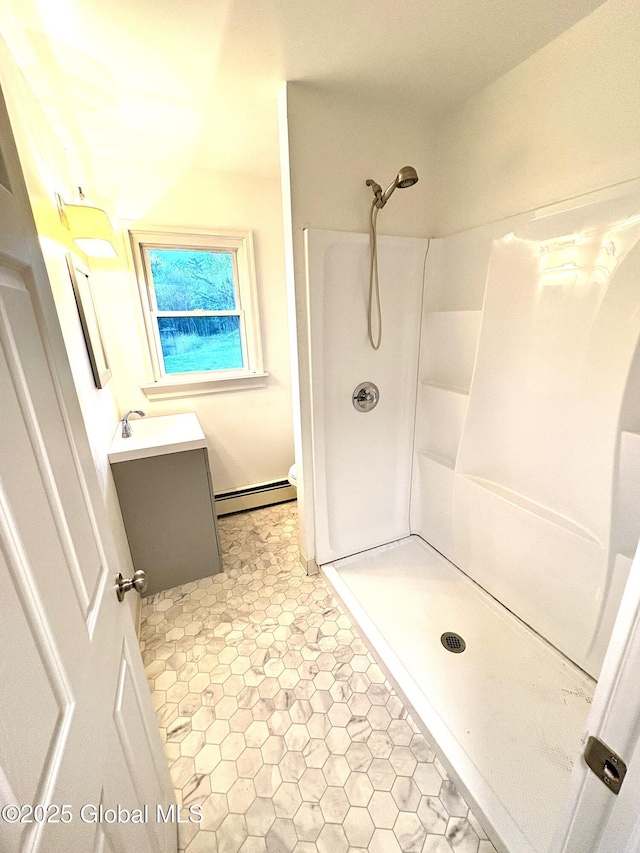 11 Mcdermott Rd, Mechanicville, NY 12118 - full bathroom featuring baseboard heating, a shower stall, vanity, and toilet