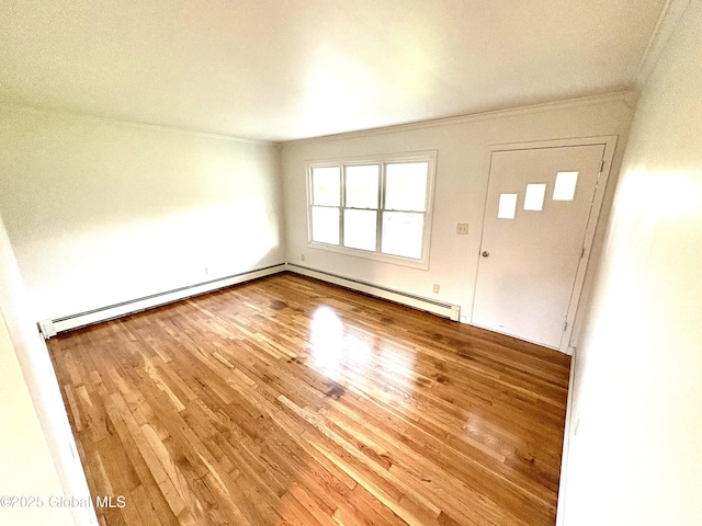 11 Mcdermott Rd, Mechanicville, NY 12118 - entrance foyer featuring baseboard heating, ornamental molding, wood finished floors, and a baseboard radiator