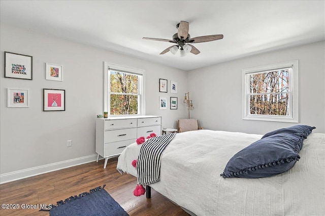 bedroom with baseboards, ceiling fan, and wood finished floors