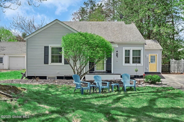 rear view of house featuring roof with shingles