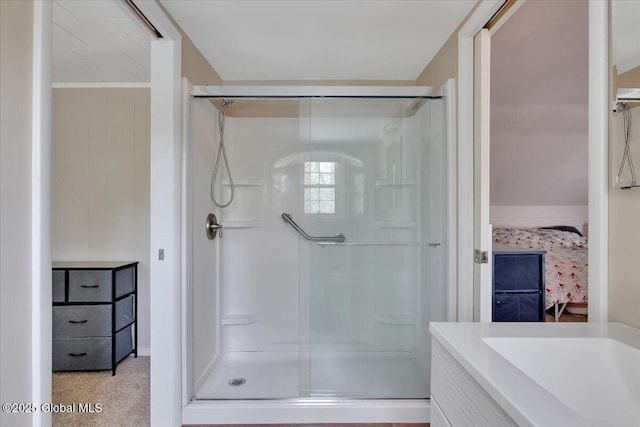 bathroom featuring a shower stall, ensuite bath, and vanity