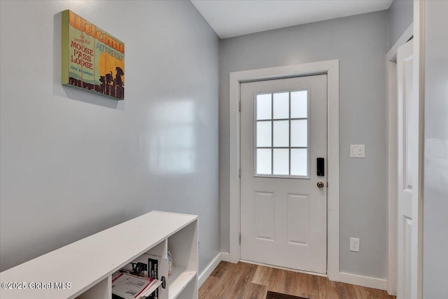 entryway with wood finished floors and baseboards