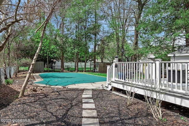 view of pool featuring a wooden deck and a fenced backyard