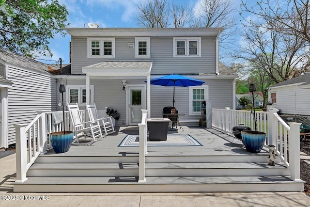 rear view of house with a wooden deck