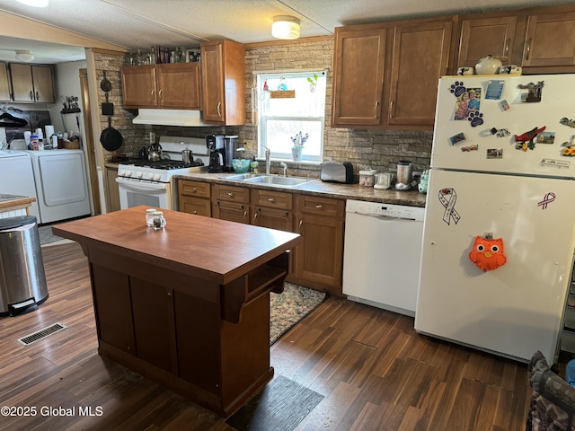 70 Dick Lynch Rd, Stillwater, NY 12170 - kitchen featuring washer and dryer, a sink, white appliances, under cabinet range hood, and visible vents