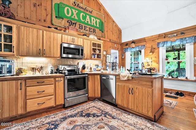 291-294 Gilchrist Hill Rd, Hartford, NY 12838 - kitchen with stainless steel appliances, hardwood / wood-style floors, a peninsula, tasteful backsplash, and high vaulted ceiling