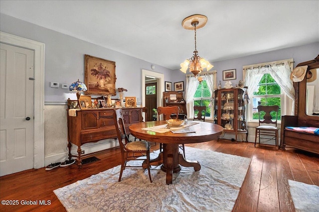 291-294 Gilchrist Hill Rd, Hartford, NY 12838 - dining area featuring a chandelier, hardwood / wood-style flooring, and wainscoting
