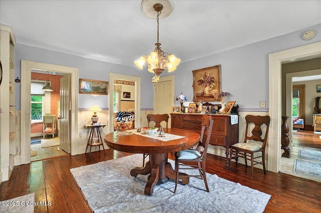 291-294 Gilchrist Hill Rd, Hartford, NY 12838 - dining area with a chandelier, wood-type flooring, and wainscoting
