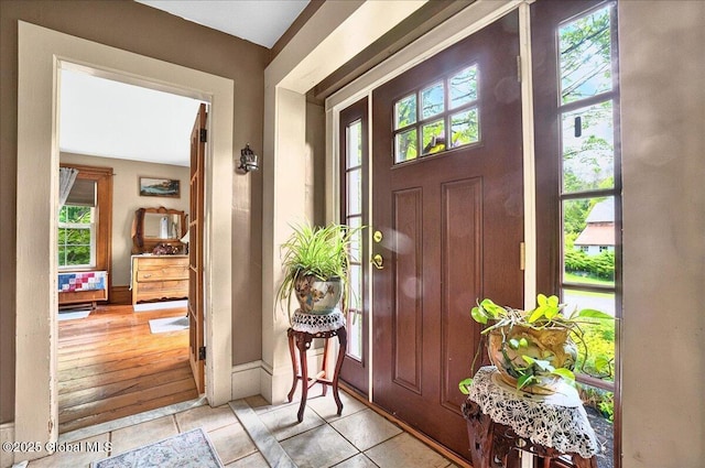 291-294 Gilchrist Hill Rd, Hartford, NY 12838 - entryway featuring plenty of natural light, light tile patterned floors, and baseboards