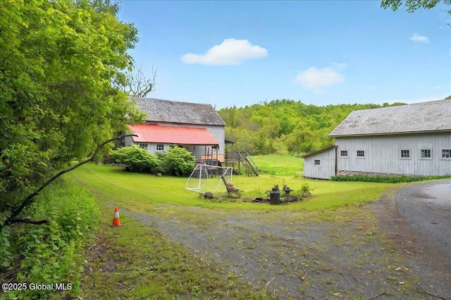 291-294 Gilchrist Hill Rd, Hartford, NY 12838 - view of grassy yard with an outdoor structure and a view of trees