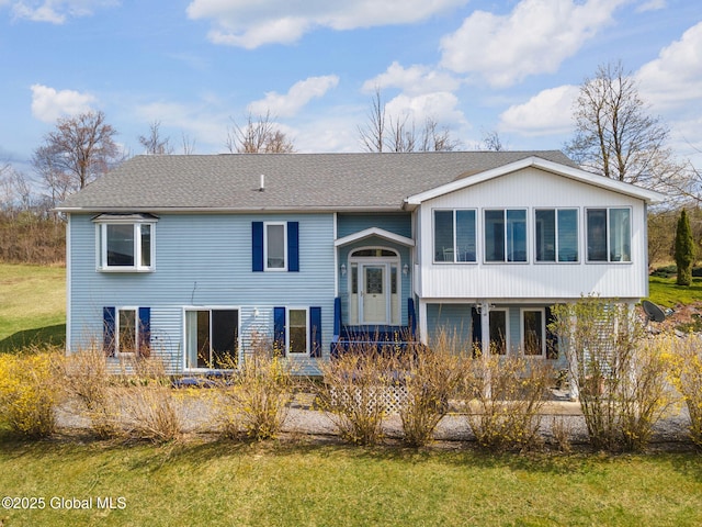 bi-level home with a front lawn
