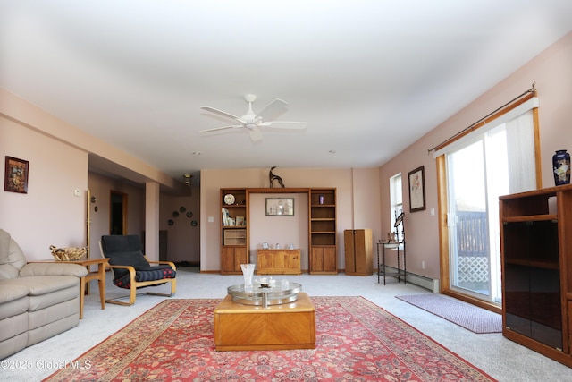 living room featuring carpet flooring, ceiling fan, baseboards, and baseboard heating