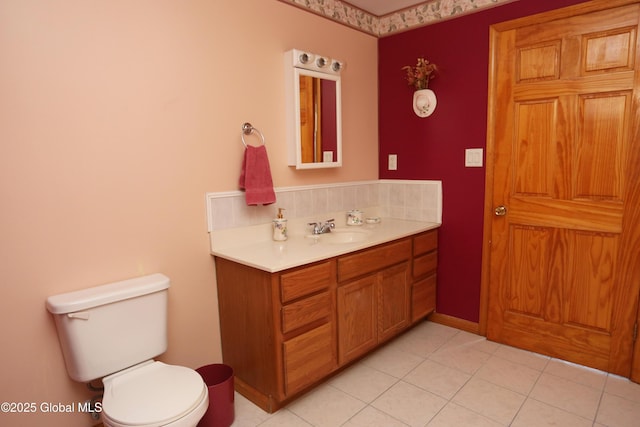 bathroom with vanity, tile patterned floors, and toilet