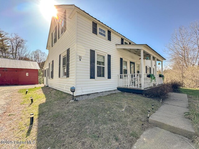 11 Mill St, Chester, NY 12817 - view of side of home featuring covered porch, a lawn, and an outdoor structure