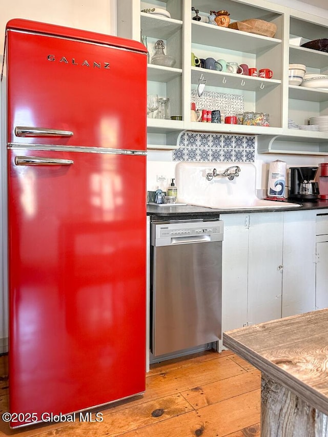 11 Mill St, Chester, NY 12817 - kitchen with light wood-type flooring, dishwasher, a sink, white cabinets, and freestanding refrigerator