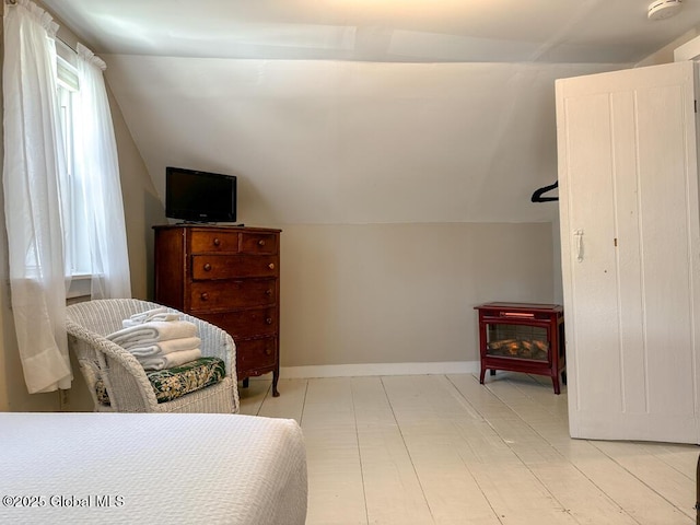 11 Mill St, Chester, NY 12817 - bedroom featuring baseboards, lofted ceiling, multiple windows, and a wood stove