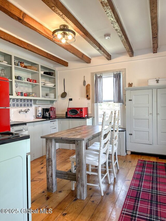 11 Mill St, Chester, NY 12817 - kitchen with open shelves, dark countertops, beamed ceiling, white cabinetry, and light wood-style flooring