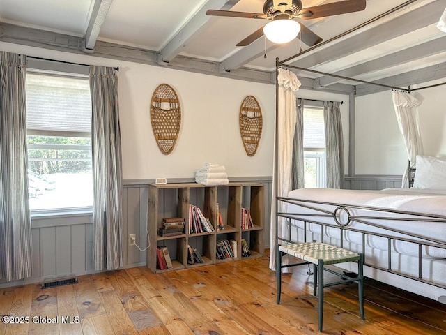 11 Mill St, Chester, NY 12817 - bedroom with visible vents, wainscoting, beamed ceiling, a decorative wall, and hardwood / wood-style floors