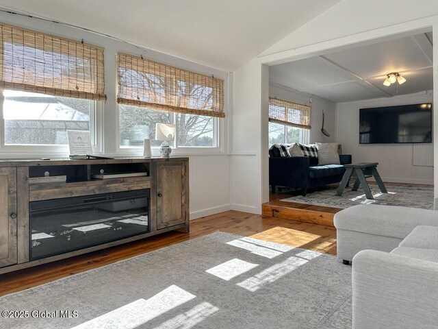 11 Mill St, Chester, NY 12817 - living area featuring wainscoting, a decorative wall, wood finished floors, and vaulted ceiling