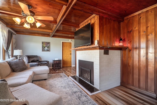 living room featuring wood walls, a ceiling fan, wood finished floors, and wooden ceiling