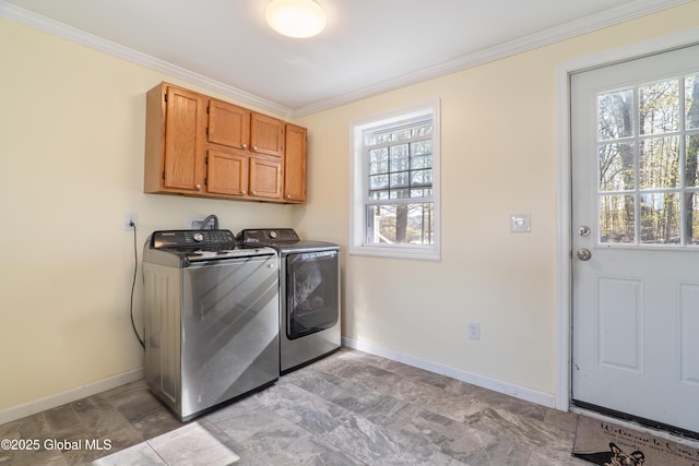 laundry room with independent washer and dryer, crown molding, a wealth of natural light, and cabinet space