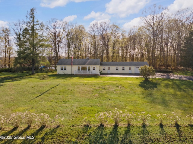rear view of property featuring a yard