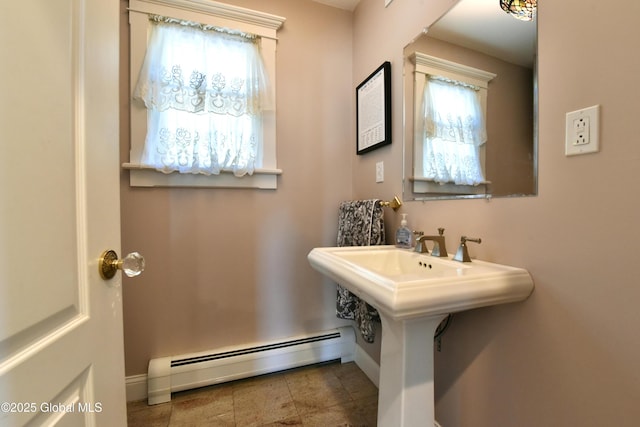 bathroom featuring baseboards, plenty of natural light, and a baseboard heating unit
