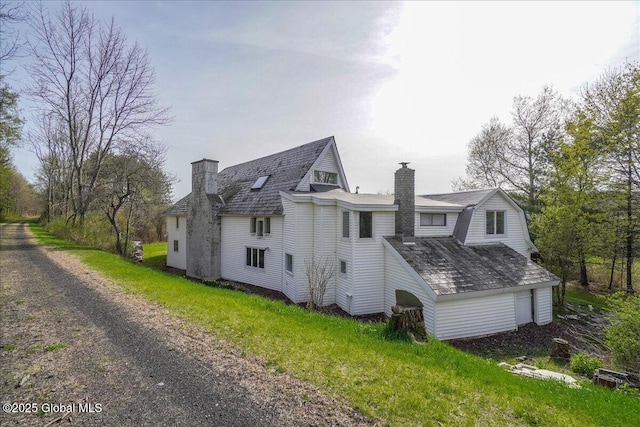 exterior space featuring a chimney and dirt driveway