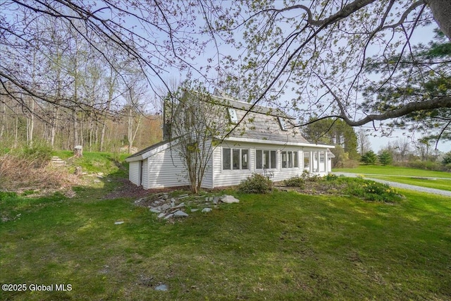 view of side of property with a lawn
