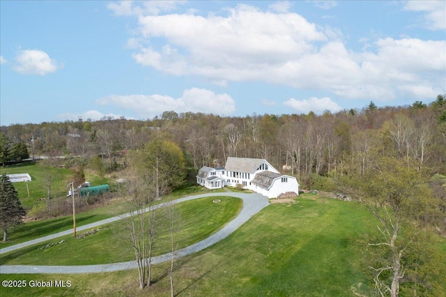 birds eye view of property featuring a view of trees