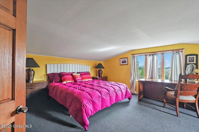 carpeted bedroom with lofted ceiling