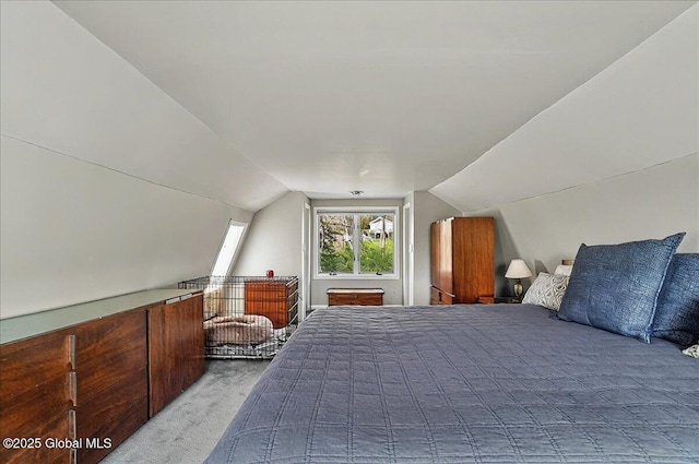 bedroom with vaulted ceiling and light colored carpet