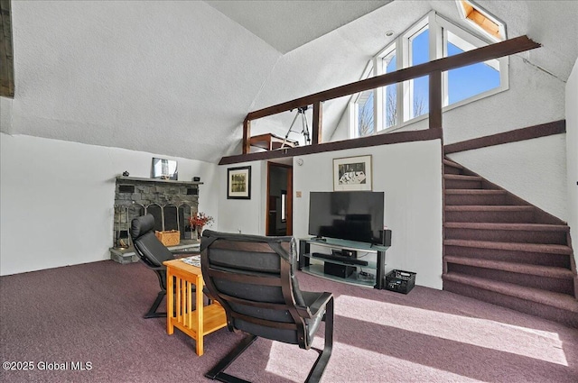 living area with stairs, a stone fireplace, high vaulted ceiling, a textured ceiling, and carpet