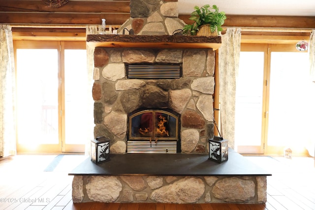 details featuring rustic walls, a fireplace, and wood finished floors