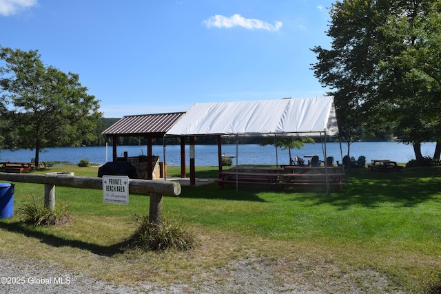 dock area featuring a water view and a lawn