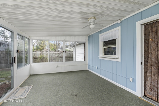 unfurnished sunroom featuring ceiling fan and a healthy amount of sunlight