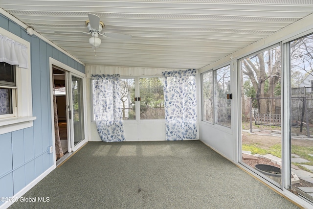 unfurnished sunroom with ceiling fan and a wealth of natural light
